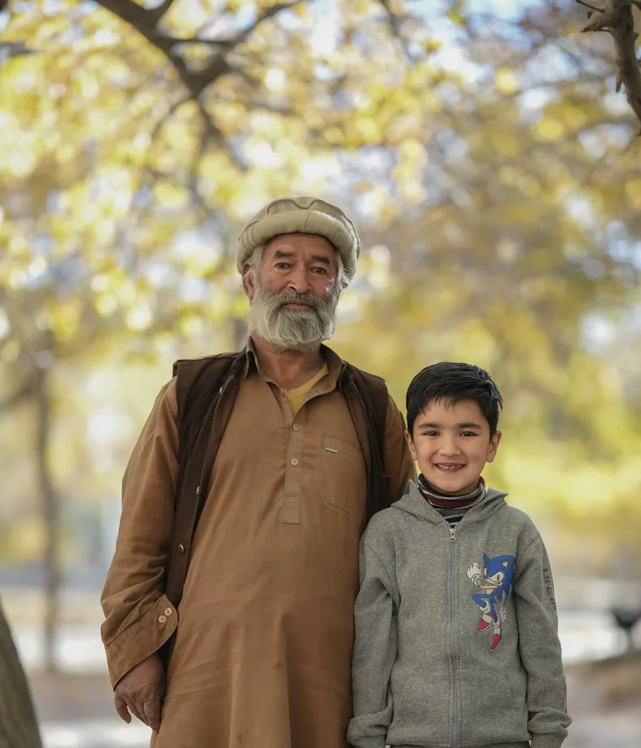His father and little brother in the orchard back home