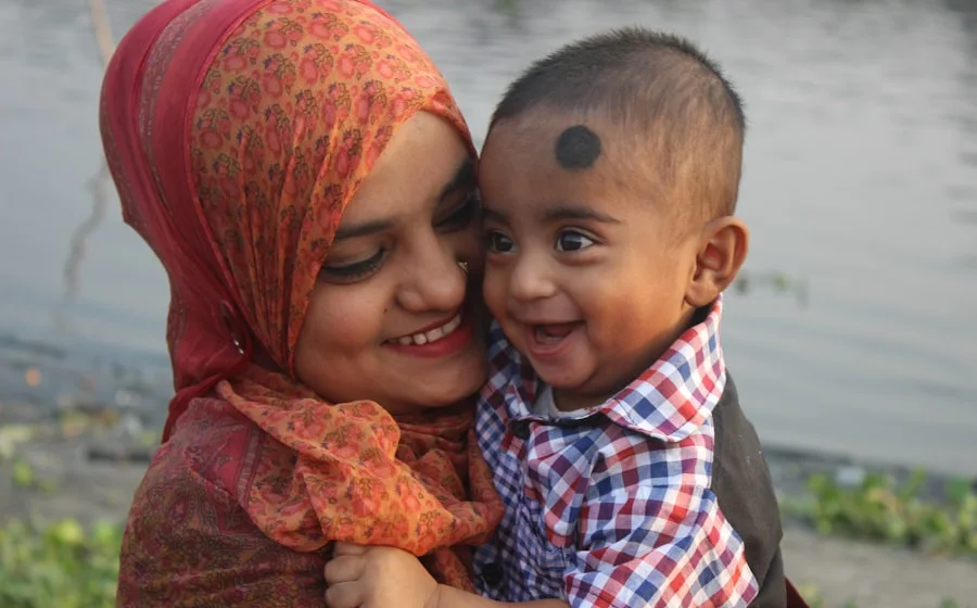 His mother hugging his little brother in Lahore